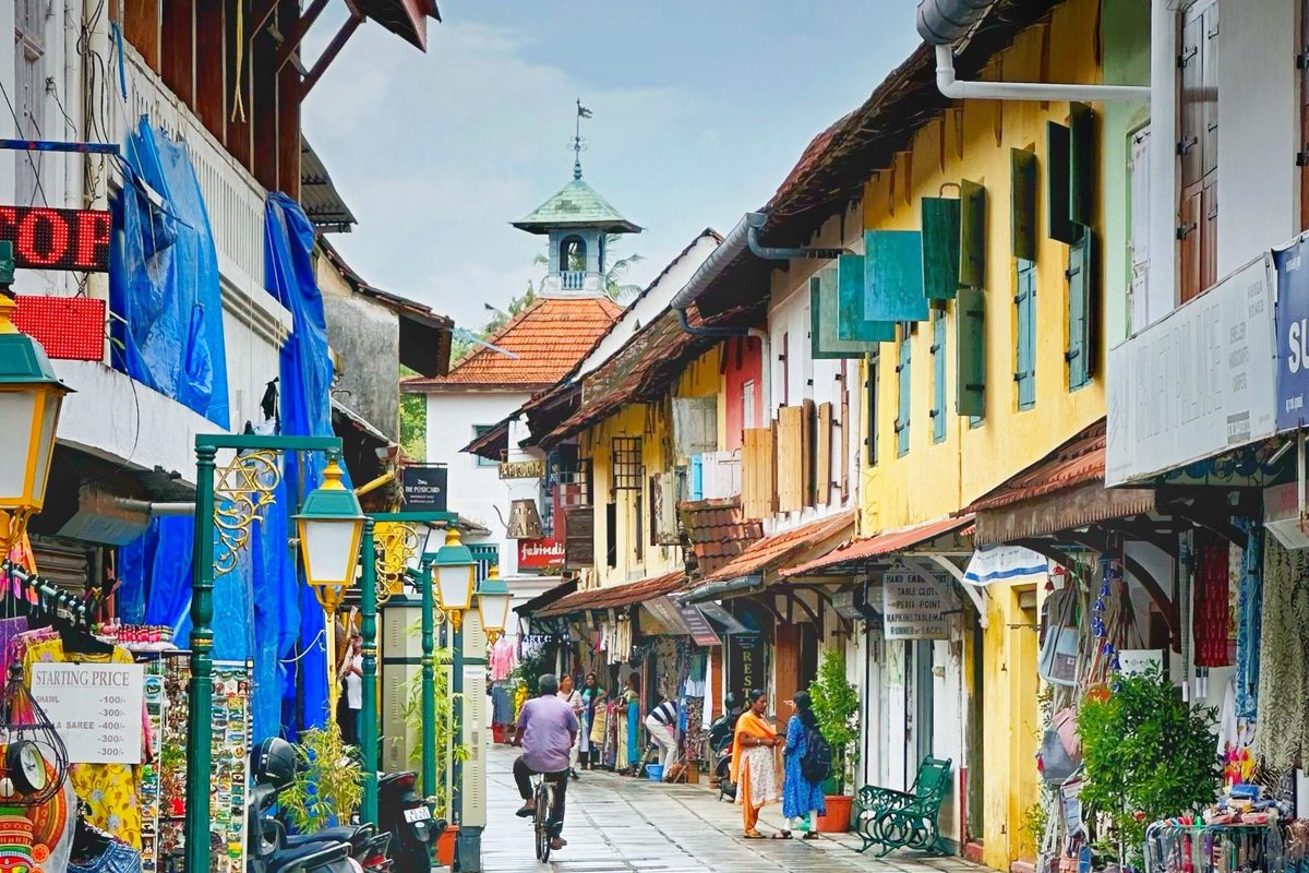 Colourful shopfronts and the synagogue clock tower on Jew Town Road, Mattancherry, Fort Kochi